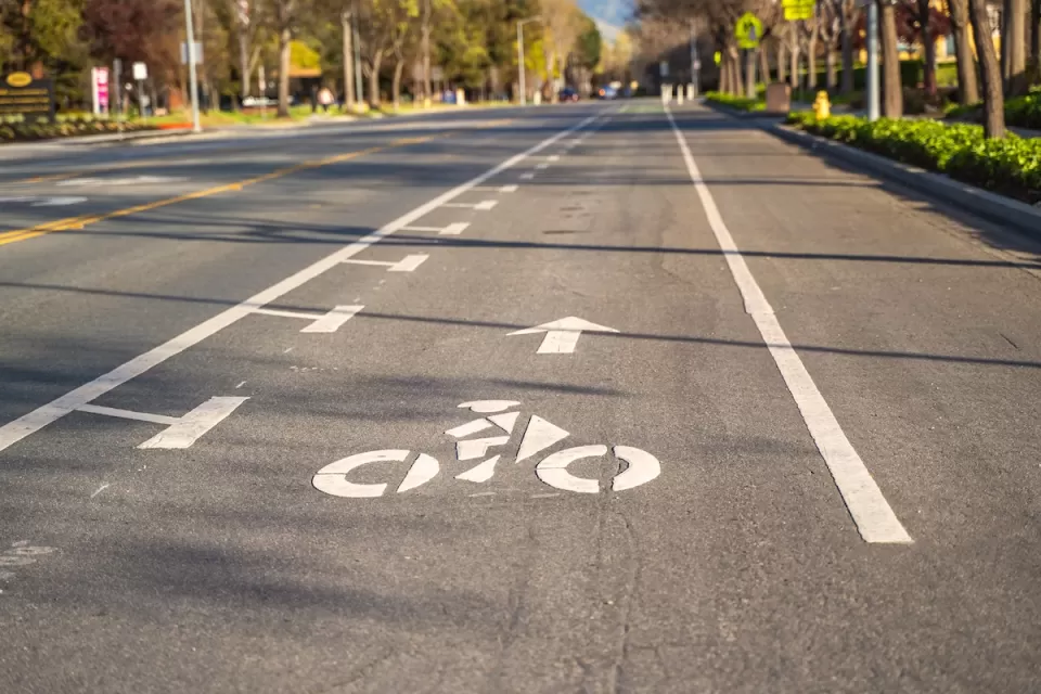Bike lane marked with white paint on asphalt street.
